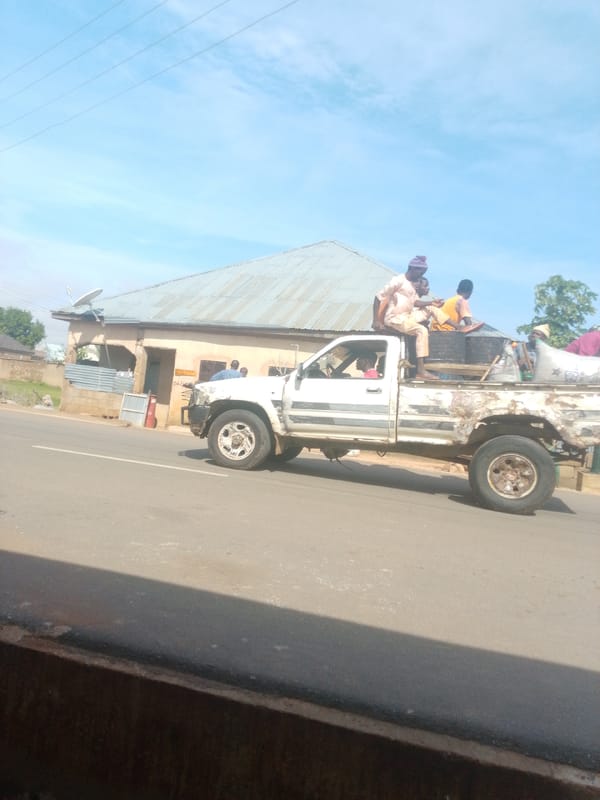 Morning street life along a paved road in Tempure, Nigeria