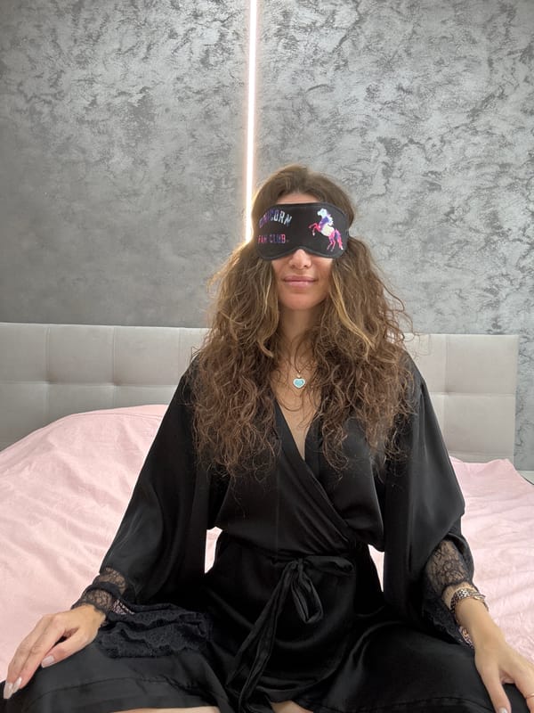 Relaxing on a pink bed with a unicorn sleep mask in Khimki