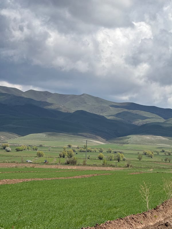 Overcast morning captured over green mountains in Tilekmat, Kyrgyzstan