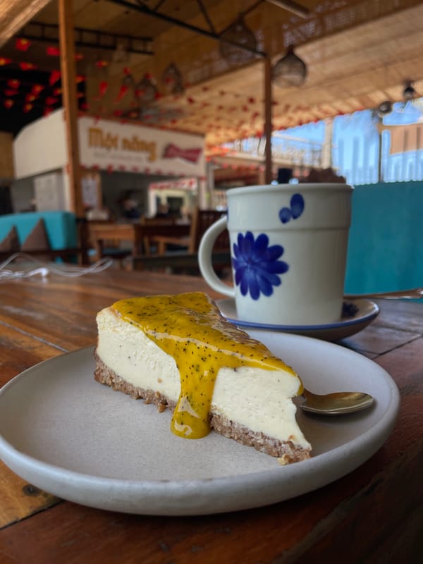 Passionfruit cheesecake at a café with a mural backdrop