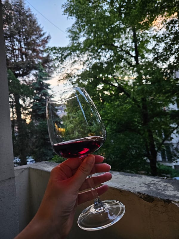 Wine glass held outdoors in Sofia balcony setting