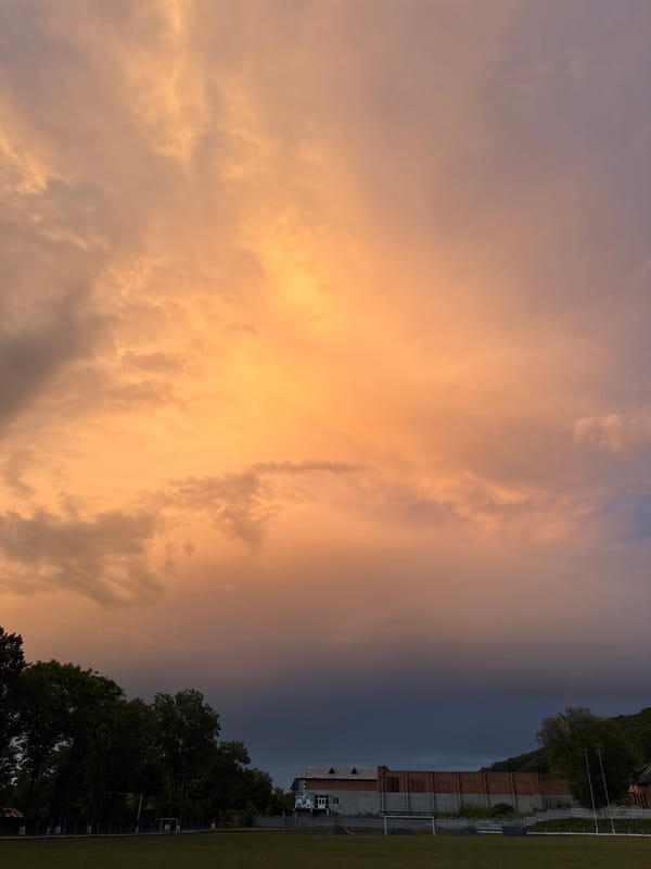 Sunset clouds over a forested stadium, multiple angles
