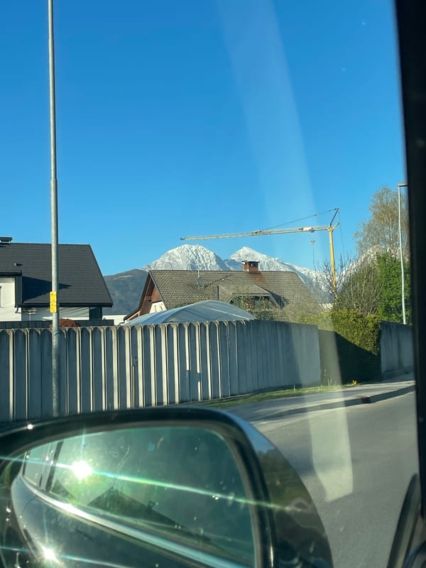 Mountain view with construction crane spotted from car in Kranj