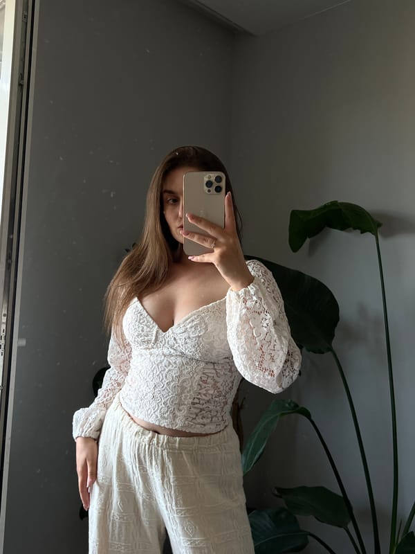 Mirror selfie session in a Ternopil room, white lace outfit