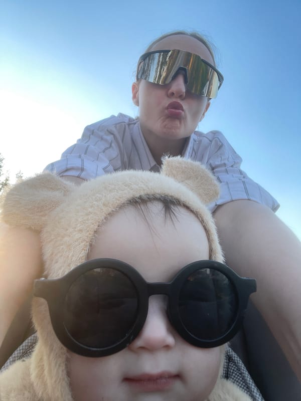 Two people photographed outdoors in sunny Russian village