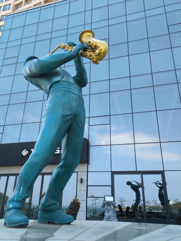 Ulsan visitor documents musician statues and beach construction scenes