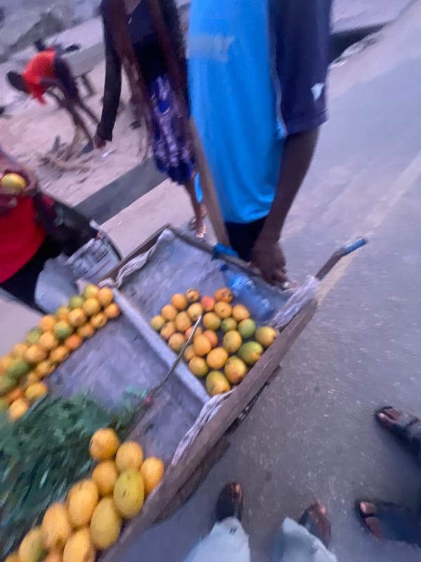 Daily life continues at Lokoja street market during evening hours