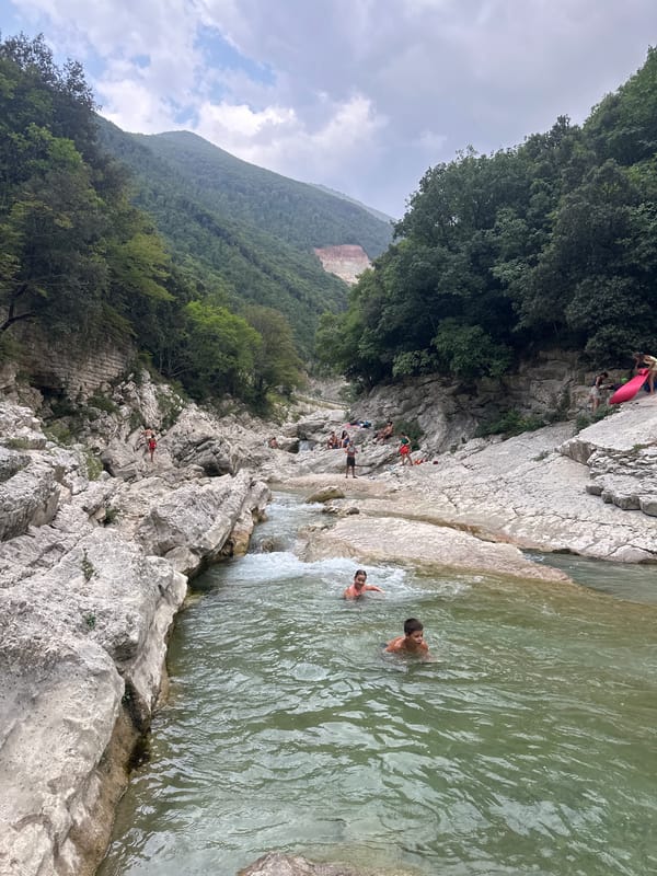 Swimming and wading in a rocky river gorge near Cagli