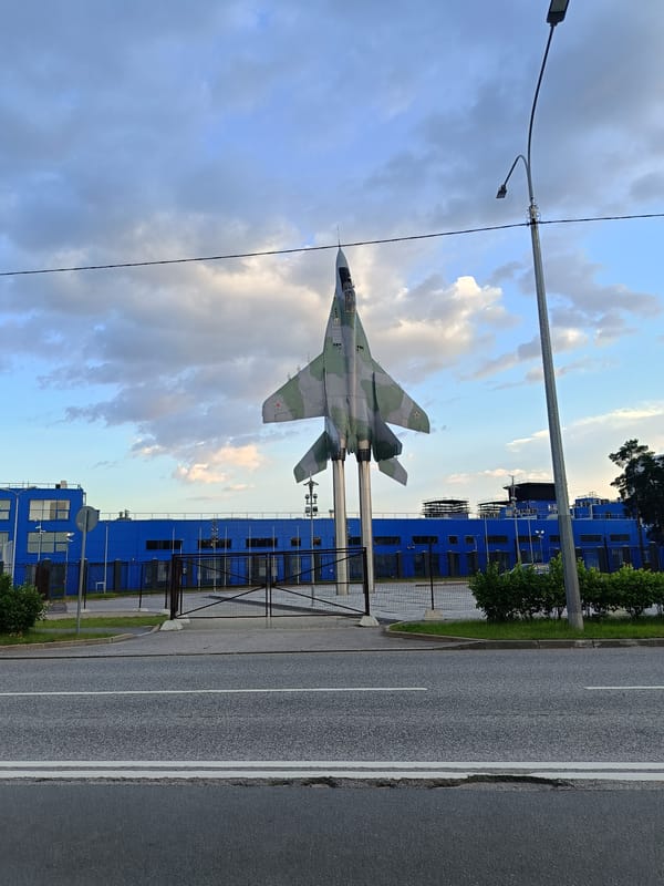 Fighter jet monument outside industrial building in Saint Petersburg
