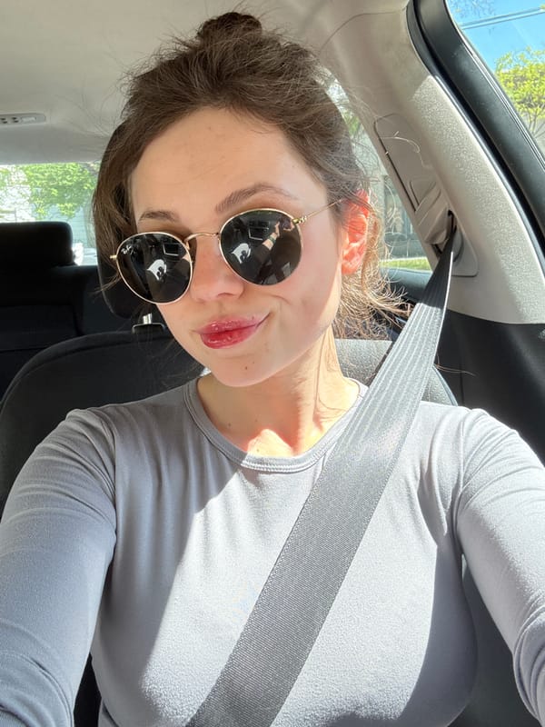 Woman poses for photos in car during daytime Budapest