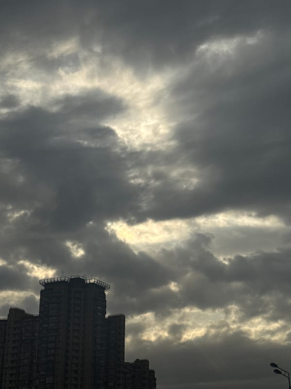 Dramatic clouds and sunlight create striking contrast over Moscow building