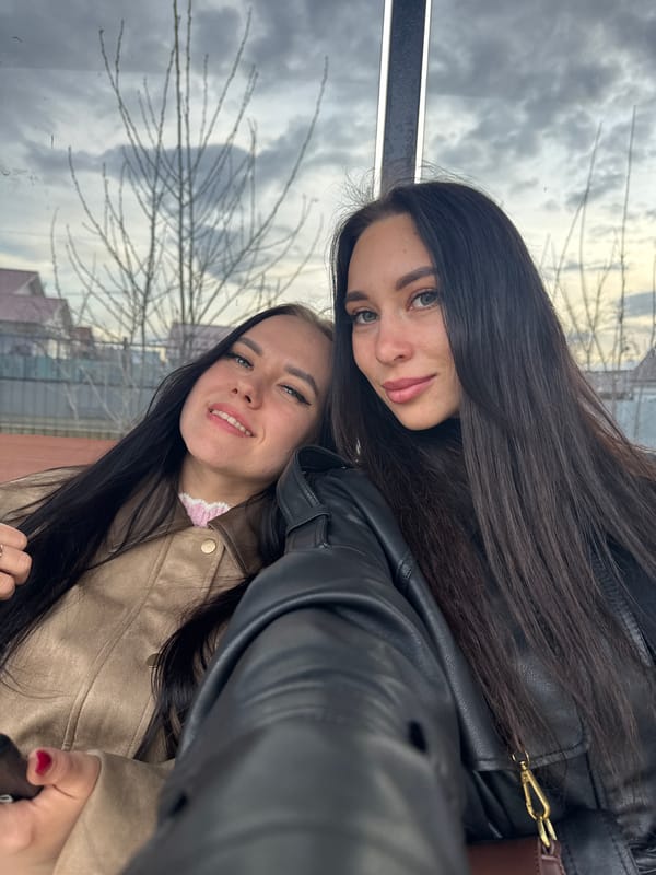 Young women take selfies by Kama River in Chaikovsky