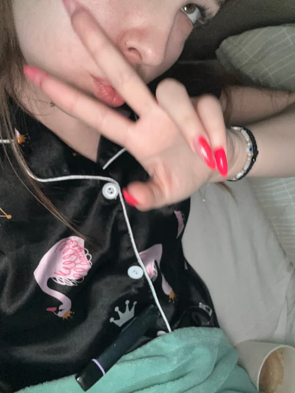Morning selfie captured in bed wearing swan-print pajamas