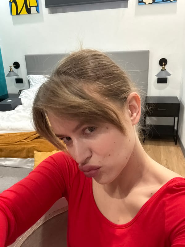 Person takes morning selfie in Crema hotel room