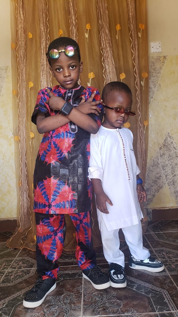 Children rest on decorated fabric in Narayi home