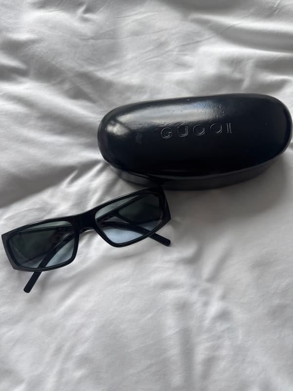 Sunglasses photographed on white fabric surface in London