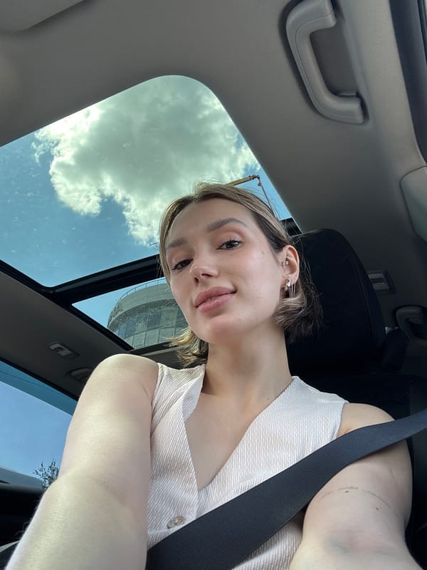 Car selfies with sunroof open, blue sky above