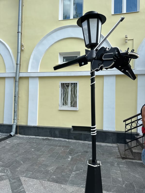 Music-themed lampposts and decorations line a pedestrian street