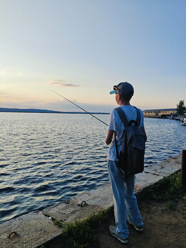 Fishing and paddleboarding on the Kama River at sunset