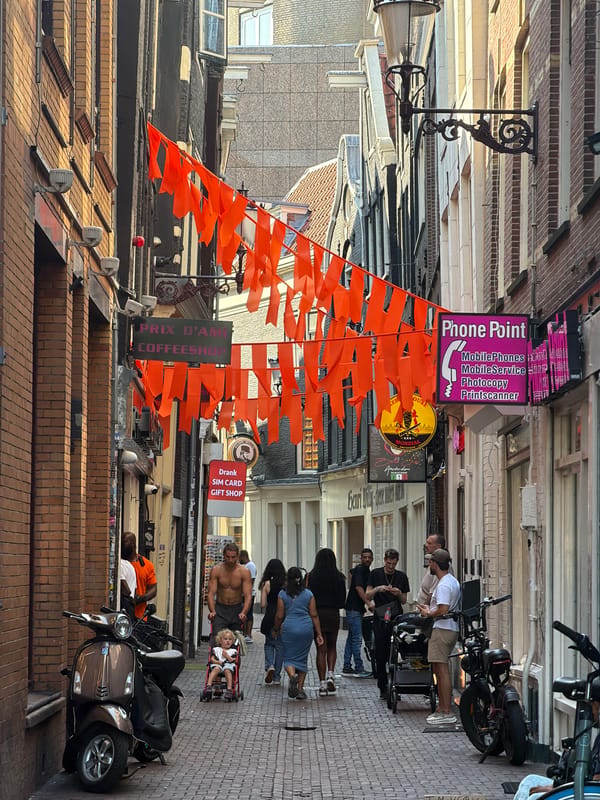 Amsterdam streets buzzing under orange flags on a June afternoon