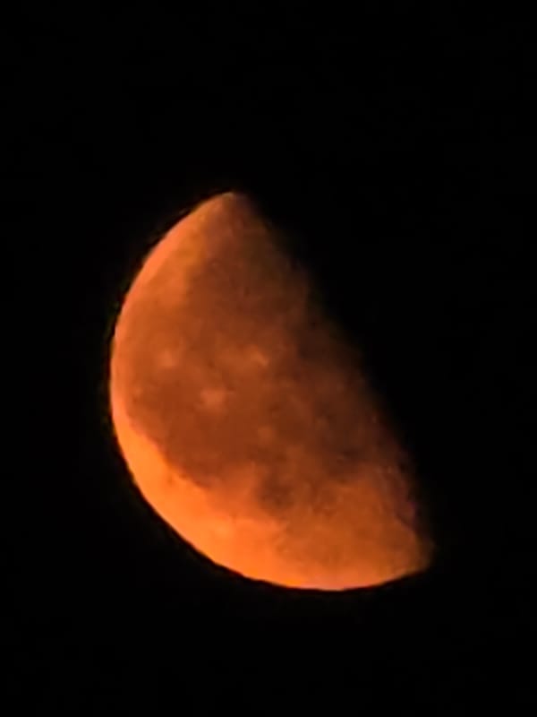 Orange moon photographed multiple ways over Yambol one evening