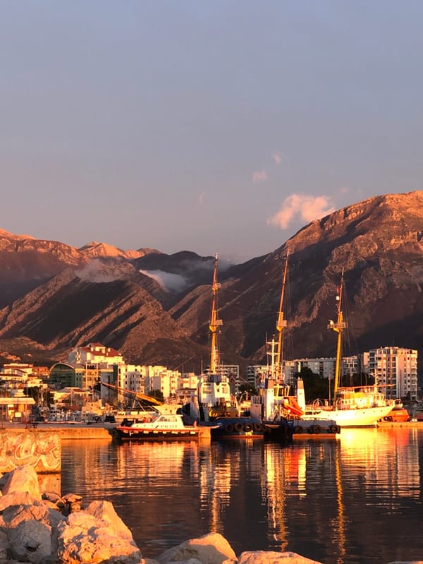 Tourists enjoy sunset harbor activities in Bar, Montenegro