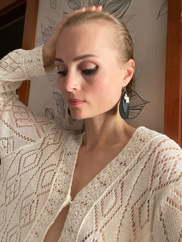 Casual indoor portrait against patterned wallpaper in Lida, Belarus