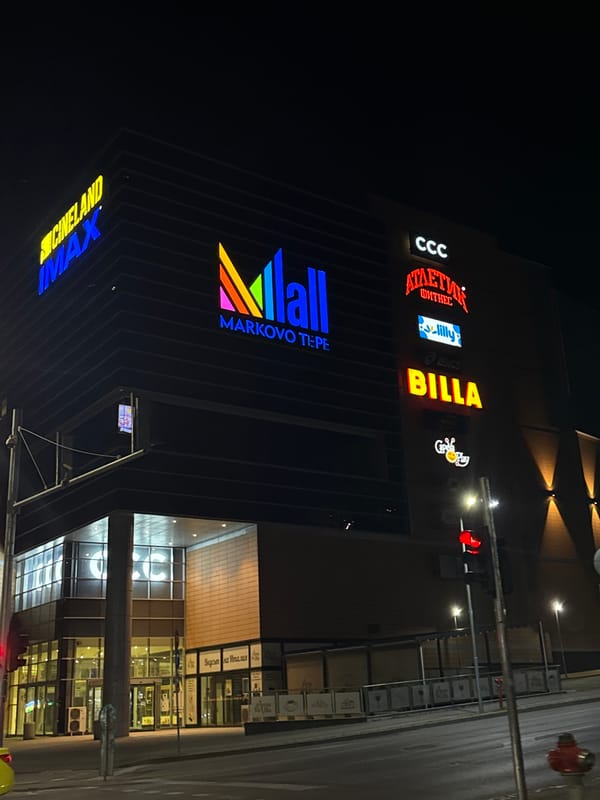 Mall Markovo Tepe displays illuminated signage during evening hours