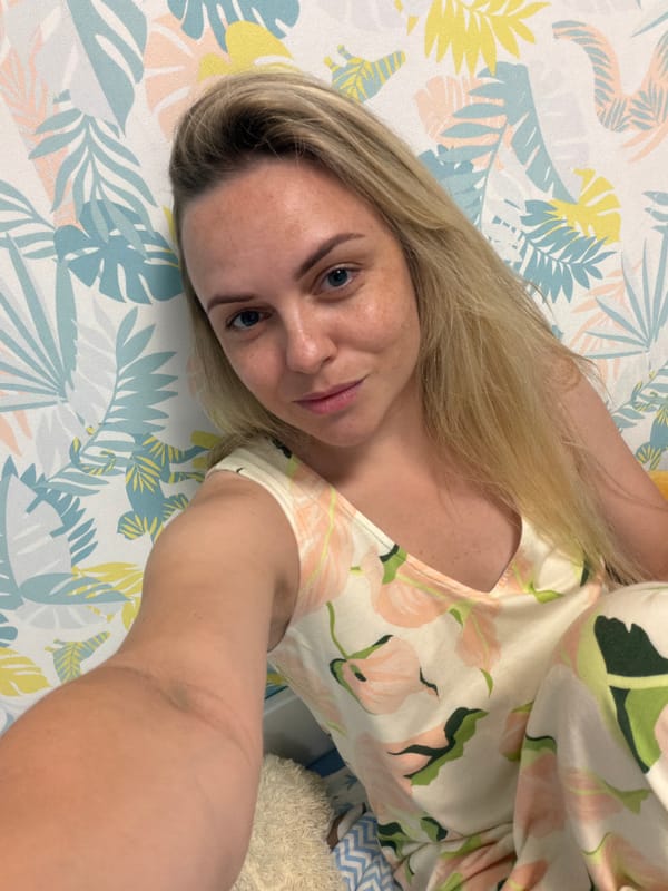 Lazy afternoon selfies with a puppy on a patterned bed