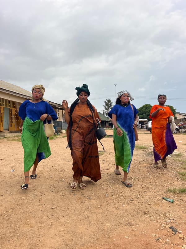 Women in traditional dress gather on rural roads
