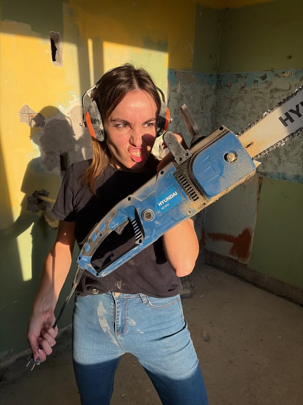 Woman operates chainsaw during home renovation in Izhevsk