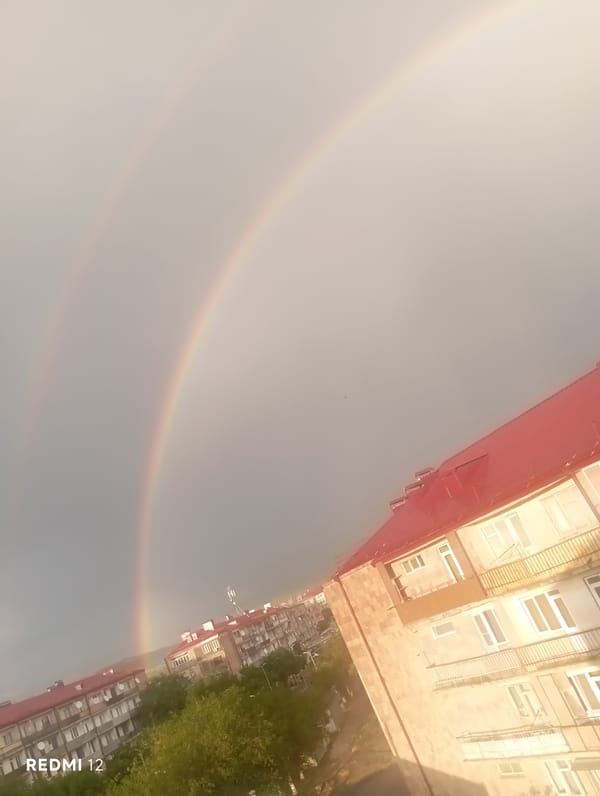 Double rainbow appears over residential Vedi, Armenia