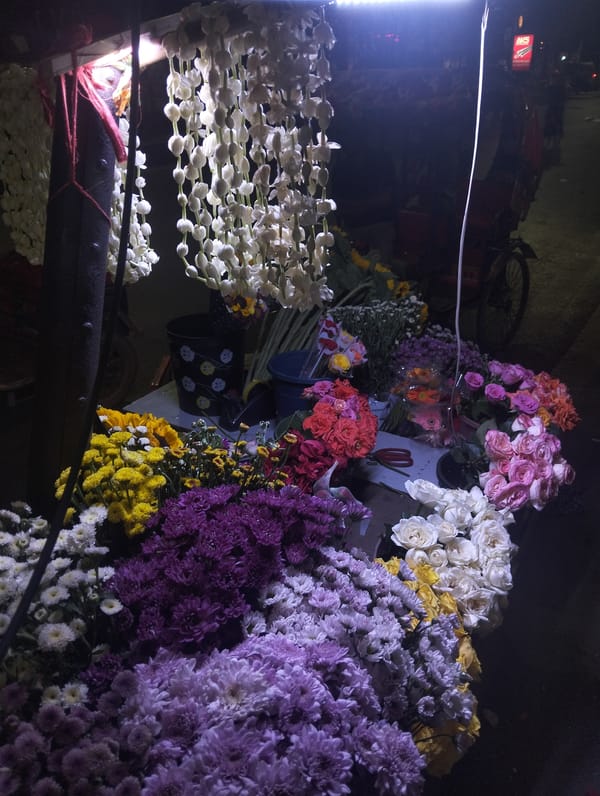 Night flower market bustling with colorful blooms in Dhaka