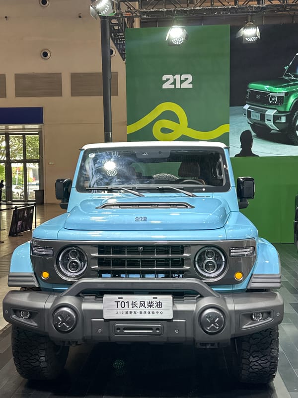Father, child browse 212 SUVs at Chongqing auto show