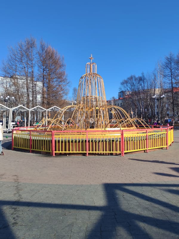 Sunny day fountain scene captured in Murmansk public square