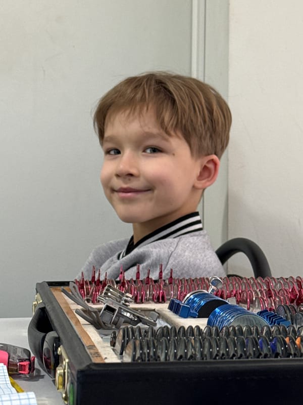 Boy examines metal springs during activity in Kuleshovka, Russia
