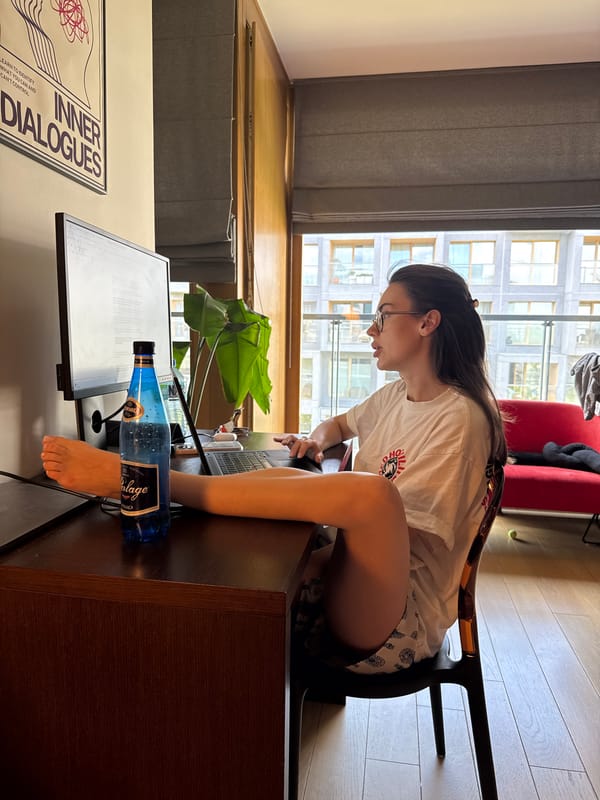 Woman works casually at home desk with feet up