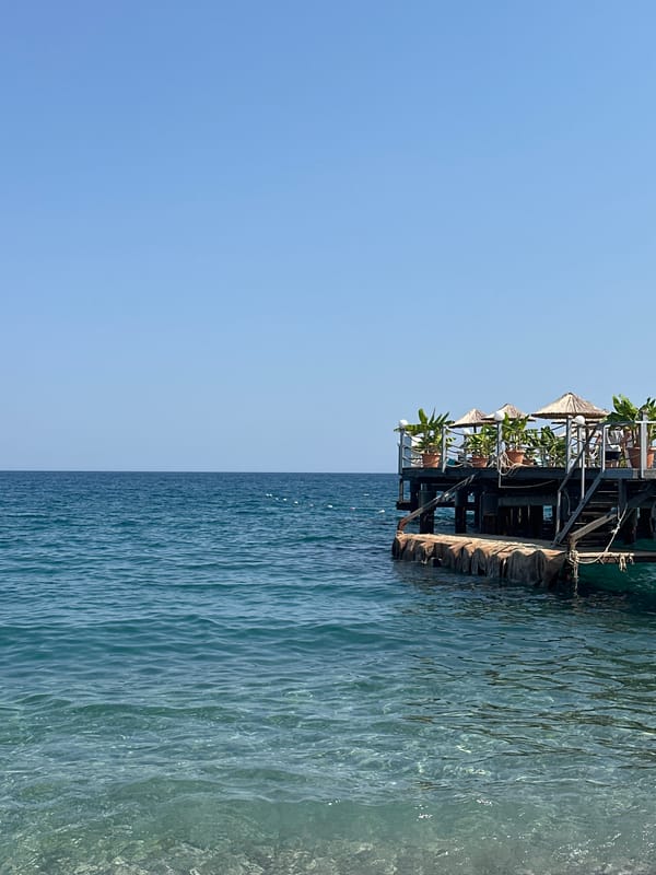 A sunny afternoon across Kemer's beaches, balconies, and parks.