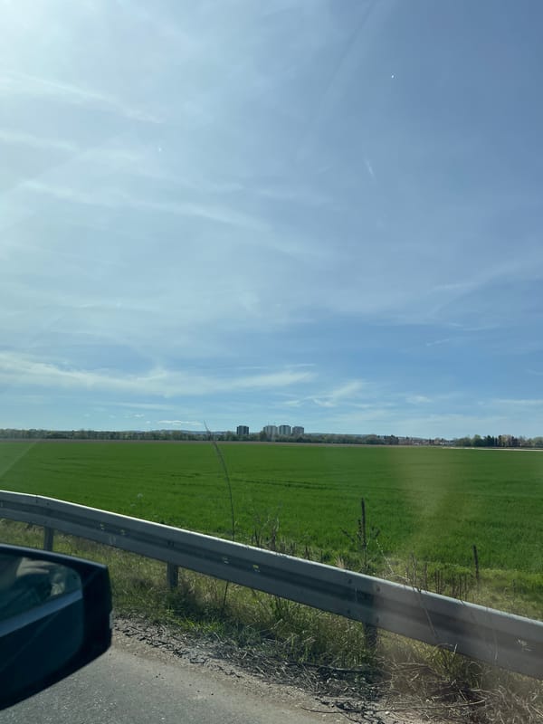 Vehicle travels rural road near Eschweiler under cloudy skies