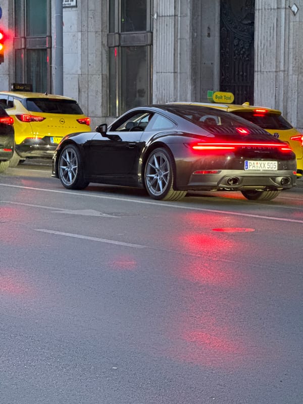 Budapest street scenes: parked luxury car and Ferris wheel captured