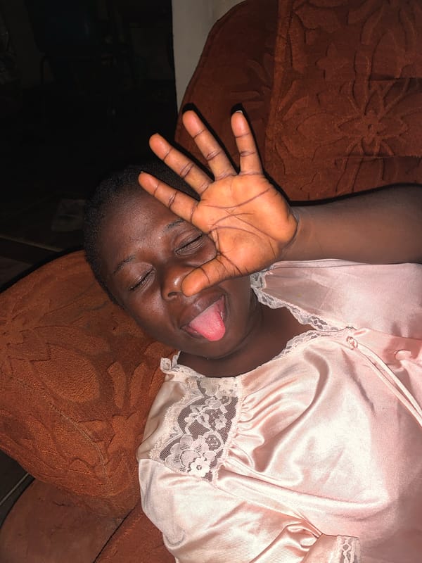 Person rests on couch in pink nightgown, Agban Nigeria