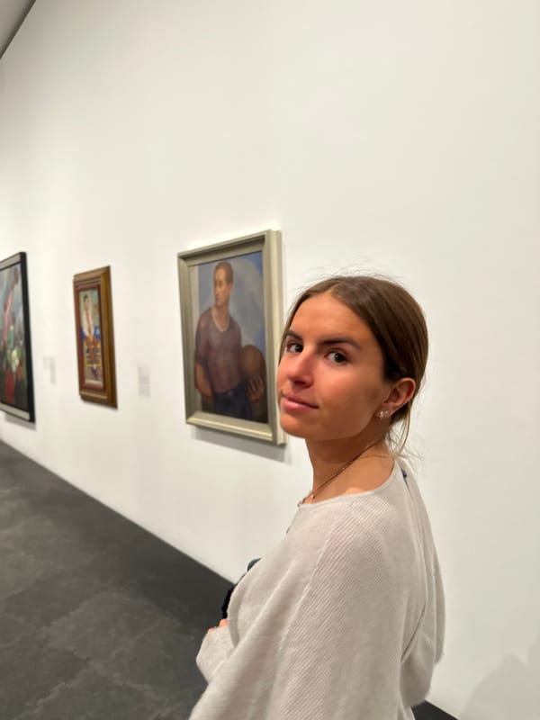 Pedestrians cross green-painted crosswalk in Mexico City evening