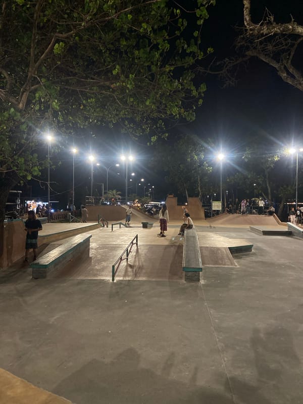 Nighttime street life and skateboarding activity observed in Kuta