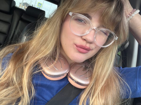 Woman drives Mazda through Naberezhnye Chelny wearing headphones, glasses