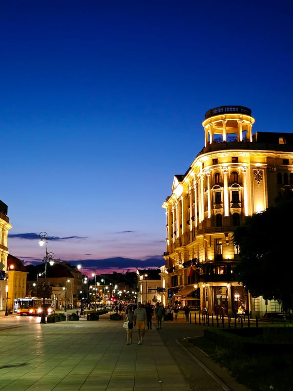 Warsaw at dusk: pedestrian walkway and ornate historic facade