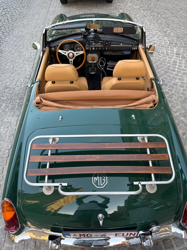 Vintage MG convertible parked among Bruges' Gothic architecture