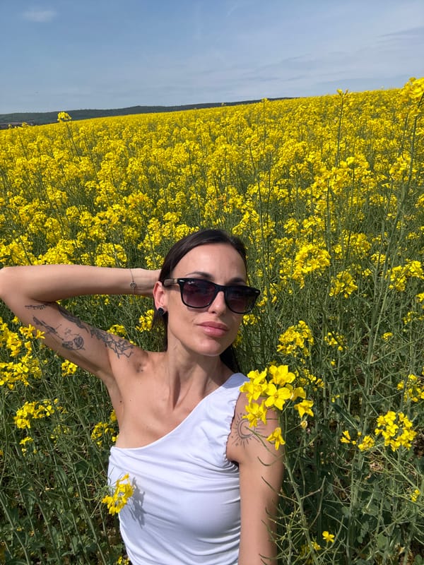 Woman enjoys peaceful moment in yellow flower field in Bulgaria