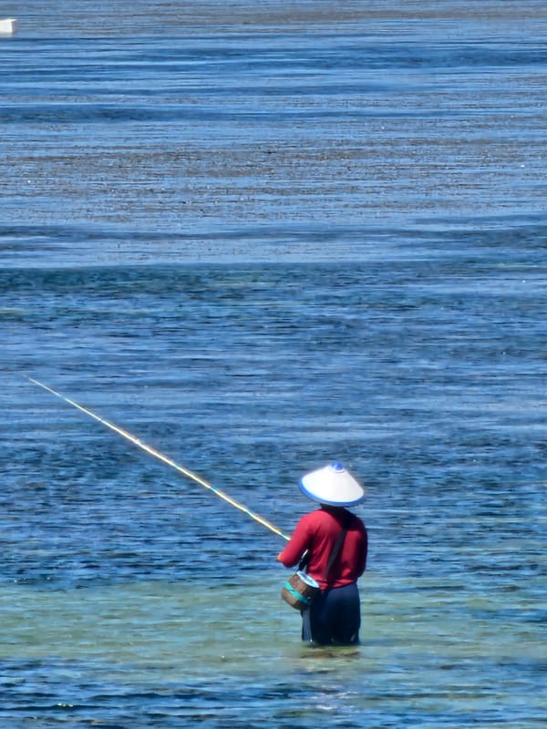 Sanur beach morning: boats, fishing, and tropical resort life