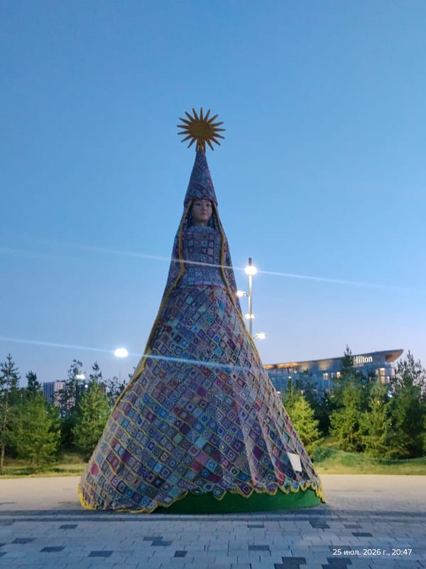 Astana landmarks and fountains lit up at dusk