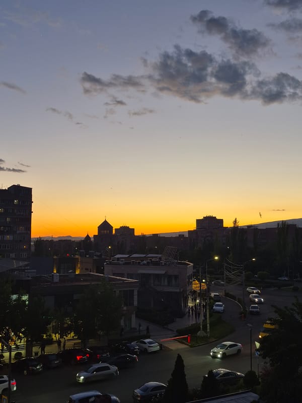 Sunset documented over Yerevan Armenia cityscape with church silhouette